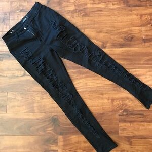 Tattered black skinny jeans